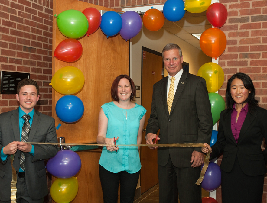 Two student LGBTQIA leaders, a GT staff member and the former president of GT cut the ribbon of the new Center.